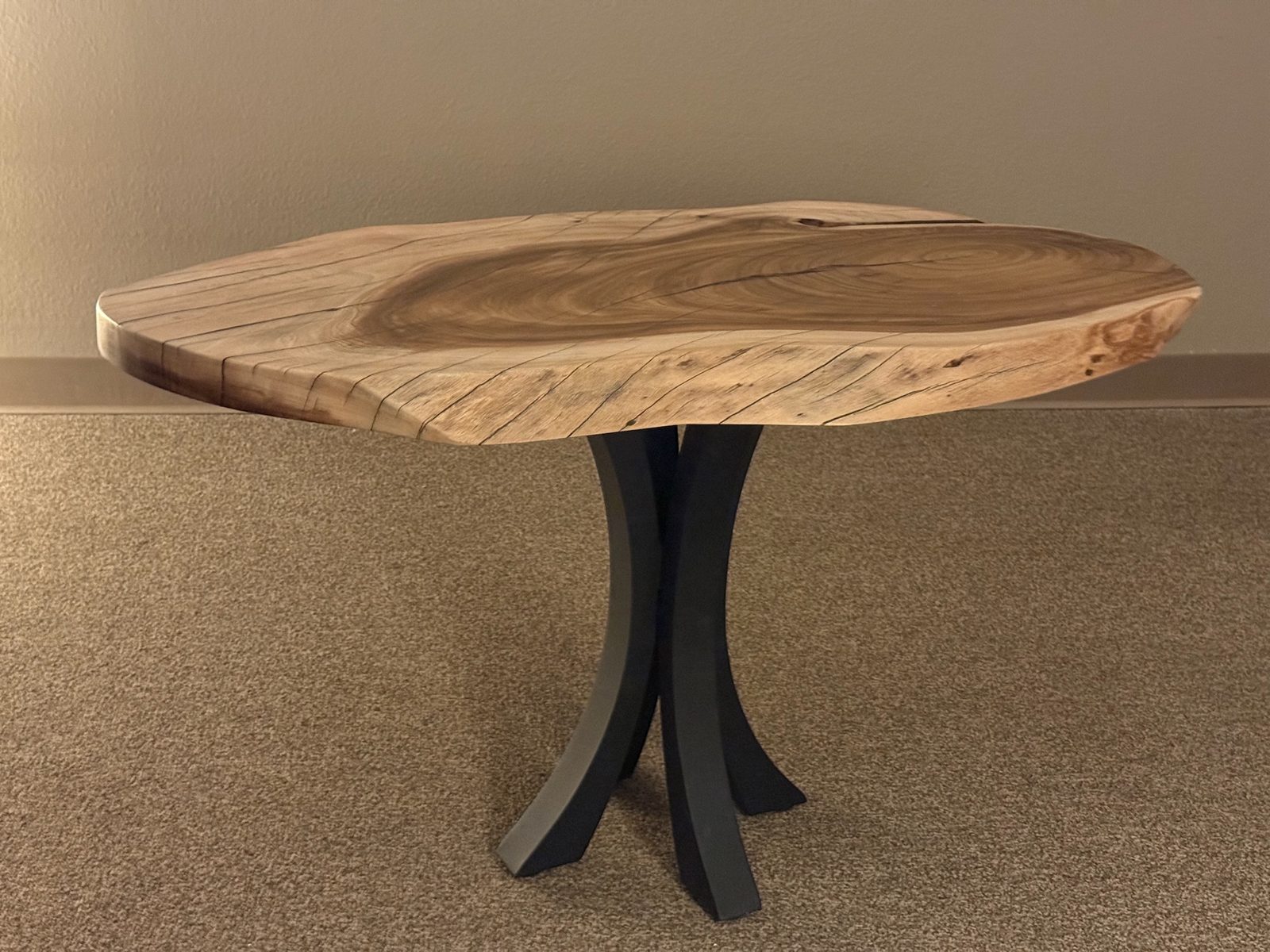 Acacia live-edge side table on the studio floor
