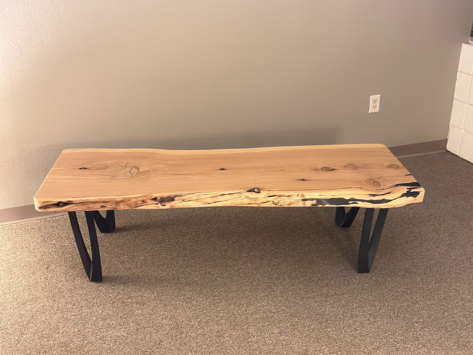 Alligator juniper live-edge coffee table on the studio floor